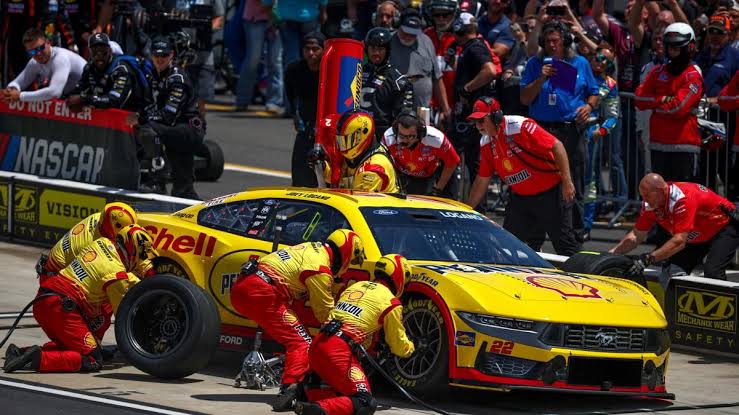 Breaking News:NASCAR officials talk to Joey Logano after Logano did a burnout near the Austin Dillon pit box, which was full of ..